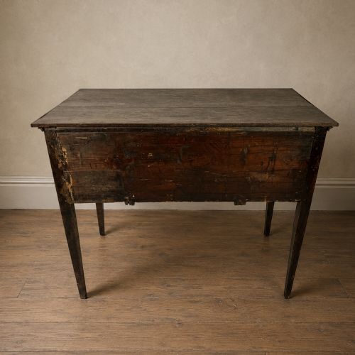 fig 3. An 18th-century Georgian dark oak lowboy side table featuring three drawers with brass handles, a shaped apron, and slender square legs.