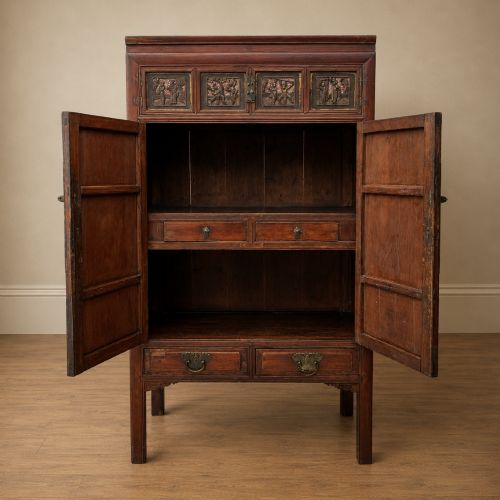 fig 3. A late 19th-century Chinese red and black lacquer cabinet with double doors decorated with bird and botanical panels above two base drawers.