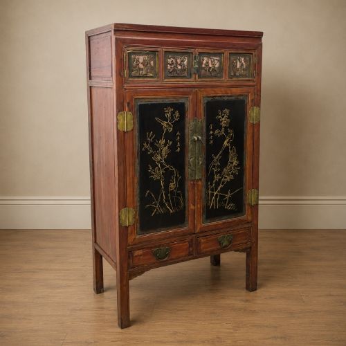 fig 4. A late 19th-century Chinese red and black lacquer cabinet with double doors decorated with bird and botanical panels above two base drawers.