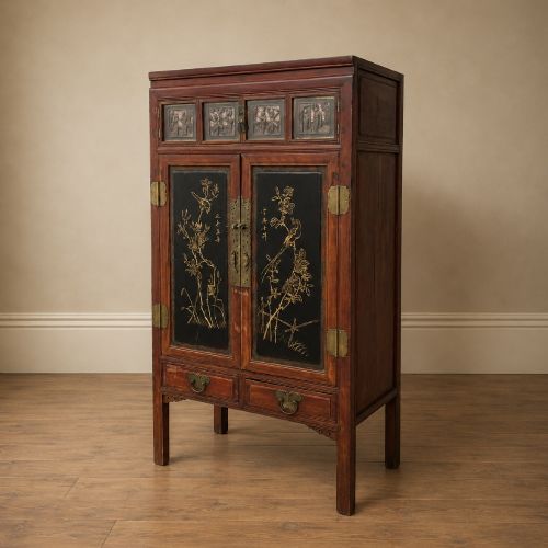 fig 5. A late 19th-century Chinese red and black lacquer cabinet with double doors decorated with bird and botanical panels above two base drawers.