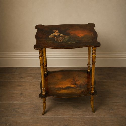fig 1. A two-tier continental side table featuring hand-painted figural scenes on shaped wooden surfaces, supported by turned gilt legs.