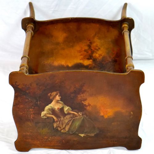 fig 2. A two-tier continental side table featuring hand-painted figural scenes on shaped wooden surfaces, supported by turned gilt legs.