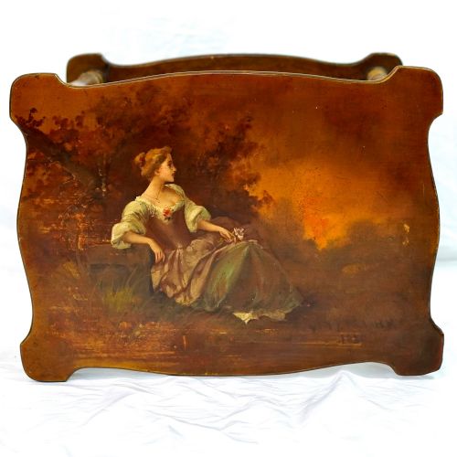 fig 3. A two-tier continental side table featuring hand-painted figural scenes on shaped wooden surfaces, supported by turned gilt legs.
