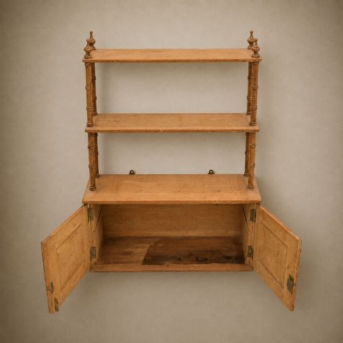 fig 3. A 19th-century wall-mounted pine rack featuring two open upper shelves supported by turned spindles with finials above an enclosed double-door cupboard.