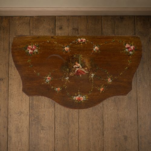 fig 5. A dark mahogany serpentine-front side cabinet with hand-painted floral swags and figurative door panel vignettes resting on slender square tapered legs.