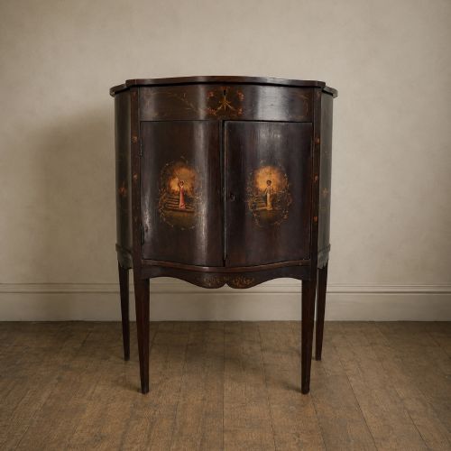 fig 8. A dark mahogany serpentine-front side cabinet with hand-painted floral swags and figurative door panel vignettes resting on slender square tapered legs.