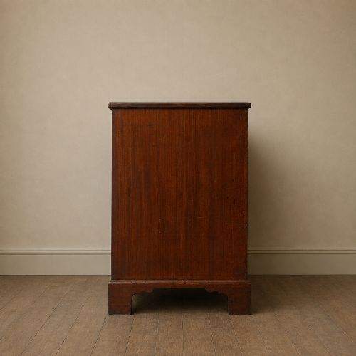 fig 2. A George II dark mahogany straight-front chest featuring four graduated long drawers with decorative brass swan-neck handles and bracket feet.