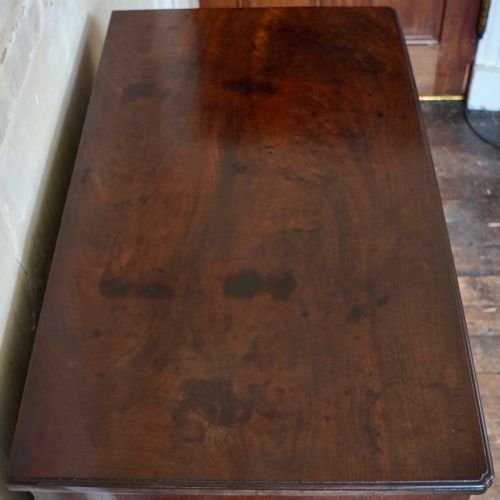 fig 10. A George II dark mahogany straight-front chest featuring four graduated long drawers with decorative brass swan-neck handles and bracket feet.