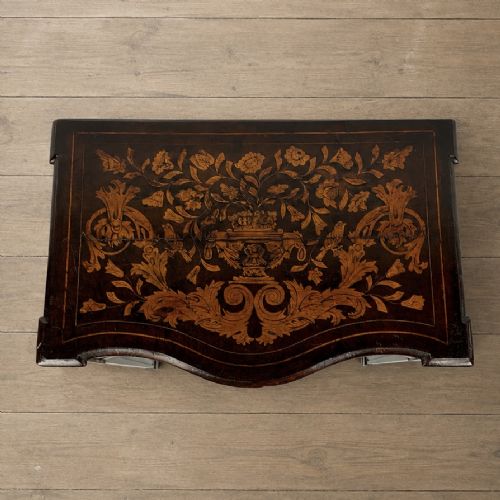 fig 1. An 18th-century Dutch walnut side table featuring a serpentine front, floral marquetry inlay, a single drawer, and four square tapered legs.
