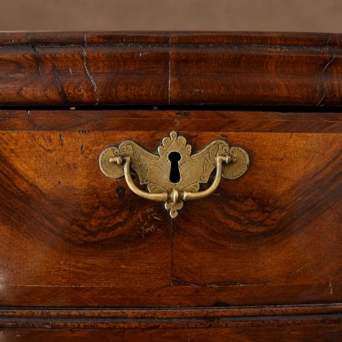 fig 7. A George I period figured walnut chest on stand featuring engraved brass escutcheons and six barley-twist legs.