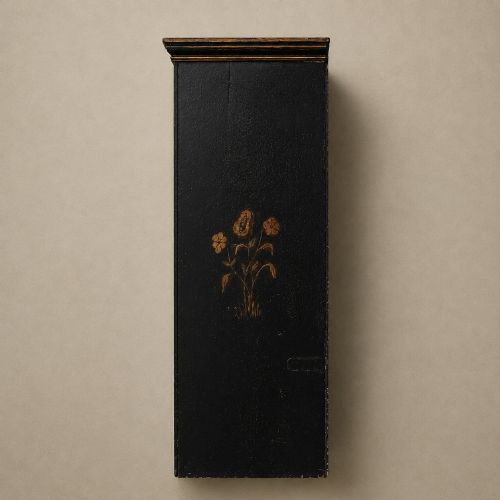 fig 4. An ebonised black wooden wall cabinet featuring an arched door panel decorated with a hand-painted exotic bird amongst green foliage.