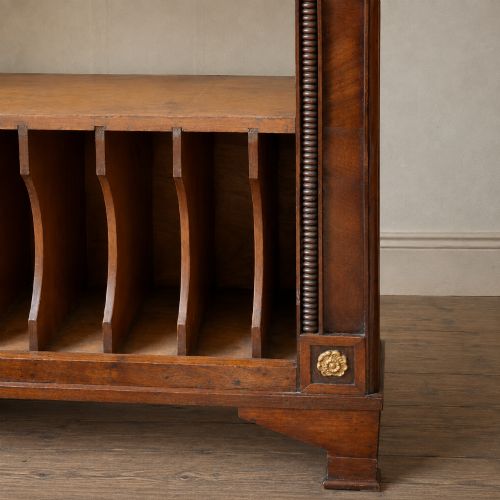 fig 4. A nineteenth-century French Empire style rosewood open bookcase featuring brass mounts and adjustable shelves above vertical dividers.