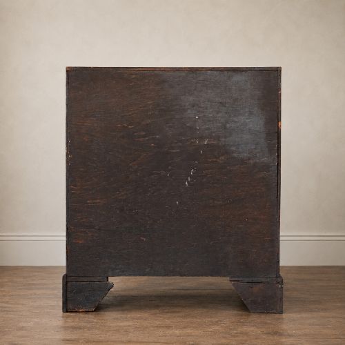 fig 4. An Early Georgian walnut bureau featuring a sloping drop-front writing lid, four graduated drawers with brass drop handles, and bracket feet.