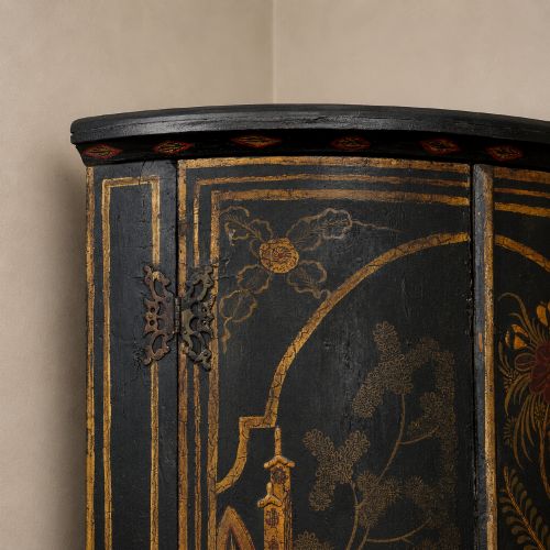 fig 3. A nineteenth-century bow-front corner cupboard crafted in dark black lacquer with gold hand-painted chinoiserie figures and architectural scenes.