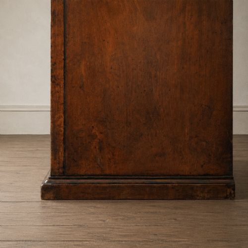 fig 5. A Victorian single-door wardrobe crafted from figured walnut wood, featuring a central arch-topped mirror panel, carved corbels, and a heavy moulded cornice.