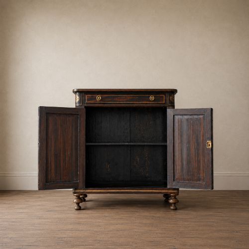 fig 1. A Regency period side cabinet featuring simulated rosewood graining, gilt corner decorations, turned flanking columns, a top drawer, and two cupboard doors.