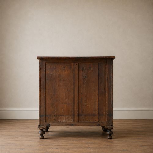 fig 4. A Regency period side cabinet featuring simulated rosewood graining, gilt corner decorations, turned flanking columns, a top drawer, and two cupboard doors.