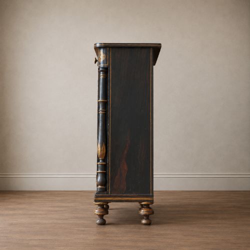 fig 5. A Regency period side cabinet featuring simulated rosewood graining, gilt corner decorations, turned flanking columns, a top drawer, and two cupboard doors.