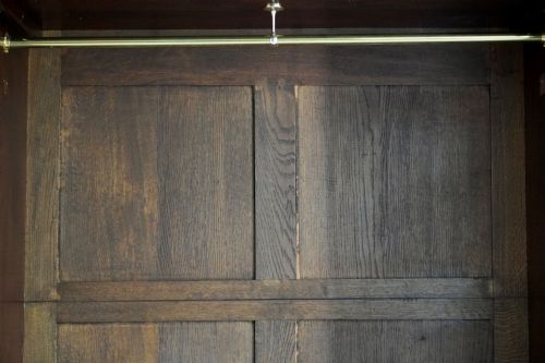 fig 4. A George III bowfront mahogany wardrobe featuring twin panelled doors with oval flame mahogany veneers above two drawers and flared bracket feet.
