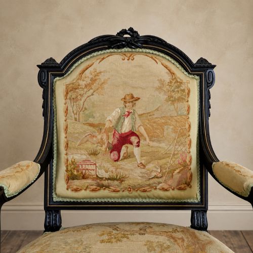fig 5. A pair of ebonised beech Louis XVI Revival salon armchairs featuring carved frames, fluted legs, padded armrests, and tapestry upholstery, accompanied by matching footstools.