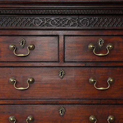 fig 1. A George III mahogany chest on chest featuring two short over six long graduated drawers, a brushing slide, blind fretwork frieze, brass swan-neck handles, and bracket feet.