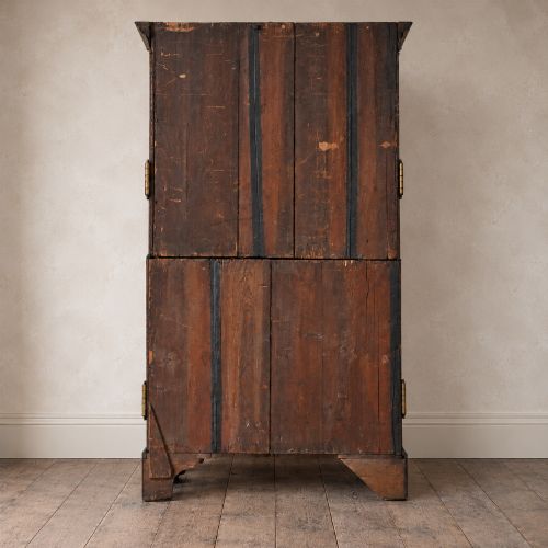 fig 5. A George III mahogany chest on chest featuring two short over six long graduated drawers, a brushing slide, blind fretwork frieze, brass swan-neck handles, and bracket feet.