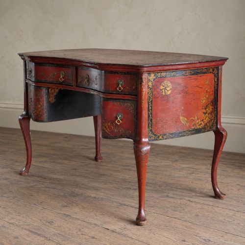 fig 2. A late nineteenth-century kidney-shaped red lacquered Chinoiserie dressing table featuring four drawers, hand-painted oriental scenes, and cabriole legs.