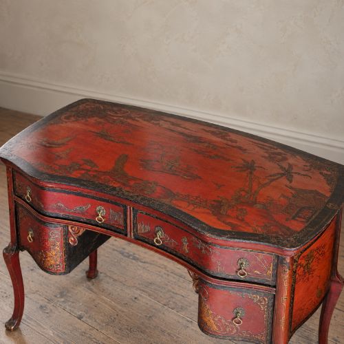 fig 3. A late nineteenth-century kidney-shaped red lacquered Chinoiserie dressing table featuring four drawers, hand-painted oriental scenes, and cabriole legs.