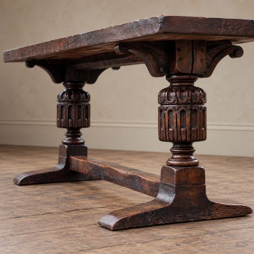 fig 4. A 17th-century oak and elm refectory dining table featuring a solid single-plank top over thick carved bulbous pedestal supports and a low central stretcher rail.