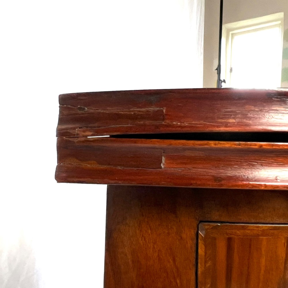 A Victorian figured walnut demi-lune card table featuring a scalloped apron, small frieze drawers, multiple turned legs, and a shaped stretcher base. View VI