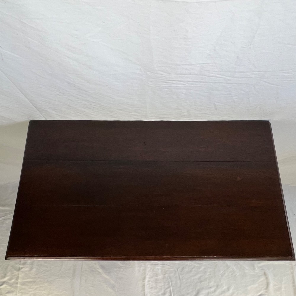A George III dark oak lowboy table featuring three drawers with brass swan-neck handles, a shaped apron, and four square straight legs. View XIII