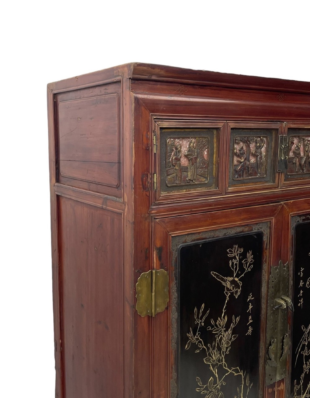 A late 19th-century Chinese red and black lacquer cabinet with double doors decorated with bird and botanical panels above two base drawers. View II