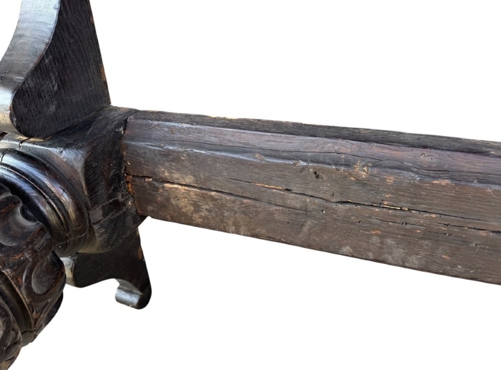 A 17th-century oak and elm refectory dining table featuring a solid single-plank top over thick carved bulbous pedestal supports and a low central stretcher rail. View V