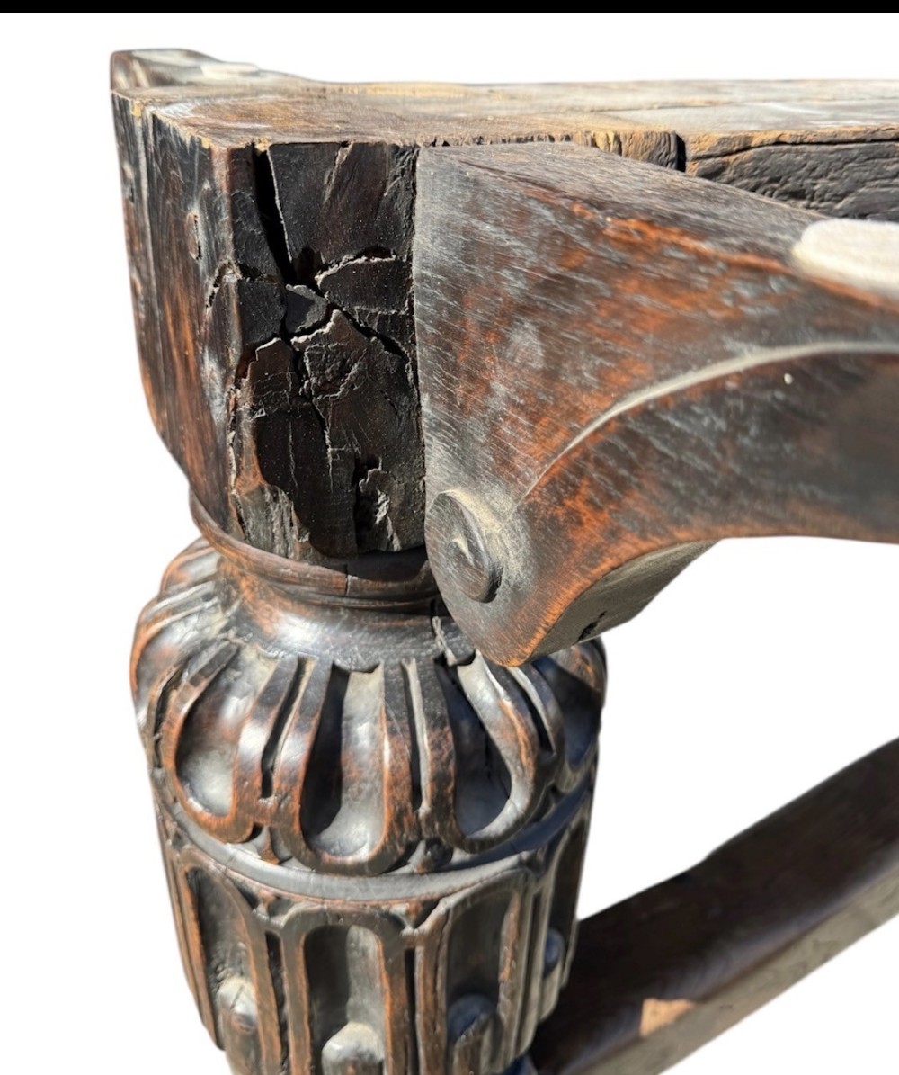 A 17th-century oak and elm refectory dining table featuring a solid single-plank top over thick carved bulbous pedestal supports and a low central stretcher rail. View VII
