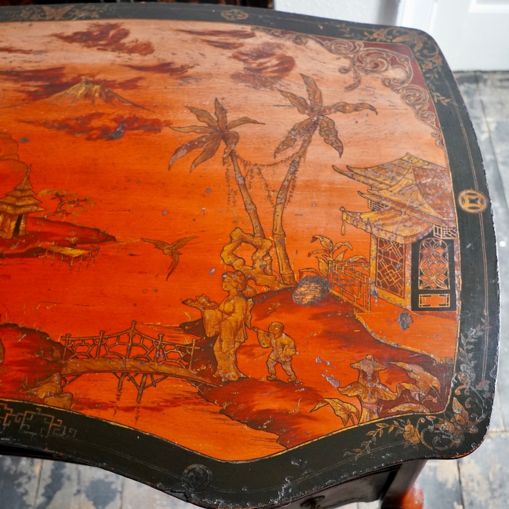 A late nineteenth-century kidney-shaped red lacquered Chinoiserie dressing table featuring four drawers, hand-painted oriental scenes, and cabriole legs. View III