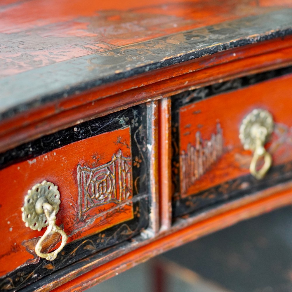 A late nineteenth-century kidney-shaped red lacquered Chinoiserie dressing table featuring four drawers, hand-painted oriental scenes, and cabriole legs. View IX