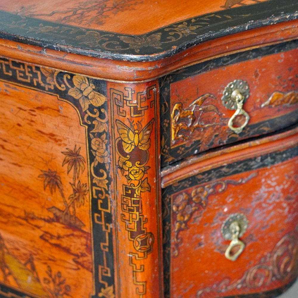A late nineteenth-century kidney-shaped red lacquered Chinoiserie dressing table featuring four drawers, hand-painted oriental scenes, and cabriole legs. View X