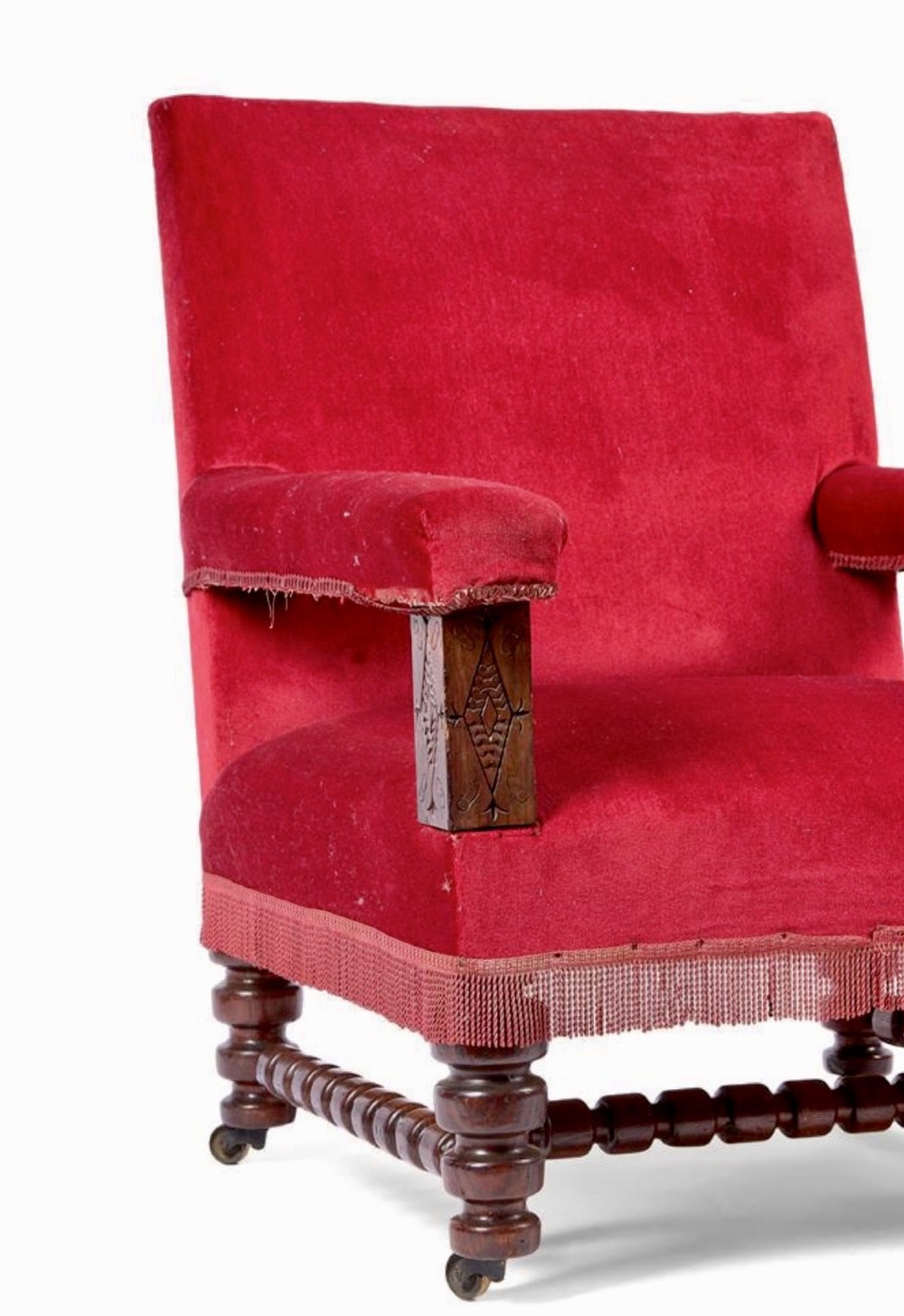 A pair of oversized Victorian armchairs upholstered in crimson red velvet with fringe trim, featuring carved oak arm supports and bobbin-turned legs. View III