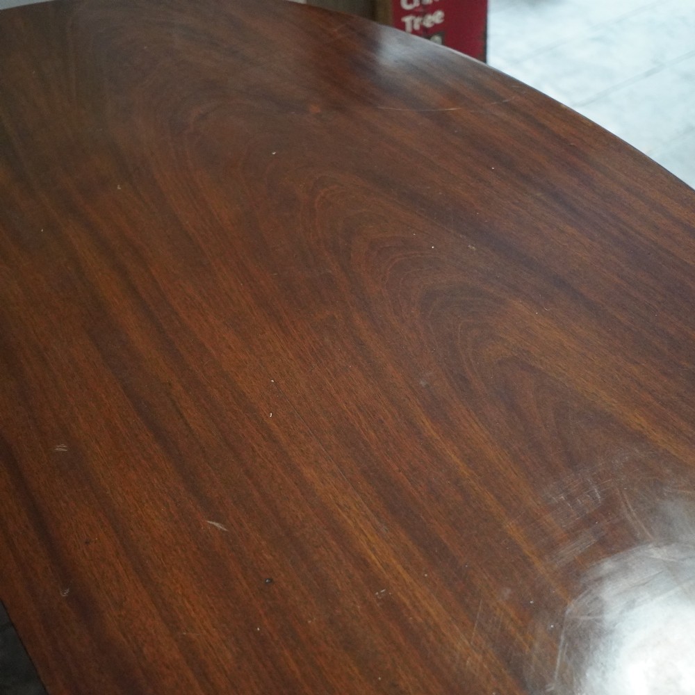 A long late George III mahogany extending dining table with D-shaped end sections, fluted friezes, carved paterae, and square tapered legs. View VIII