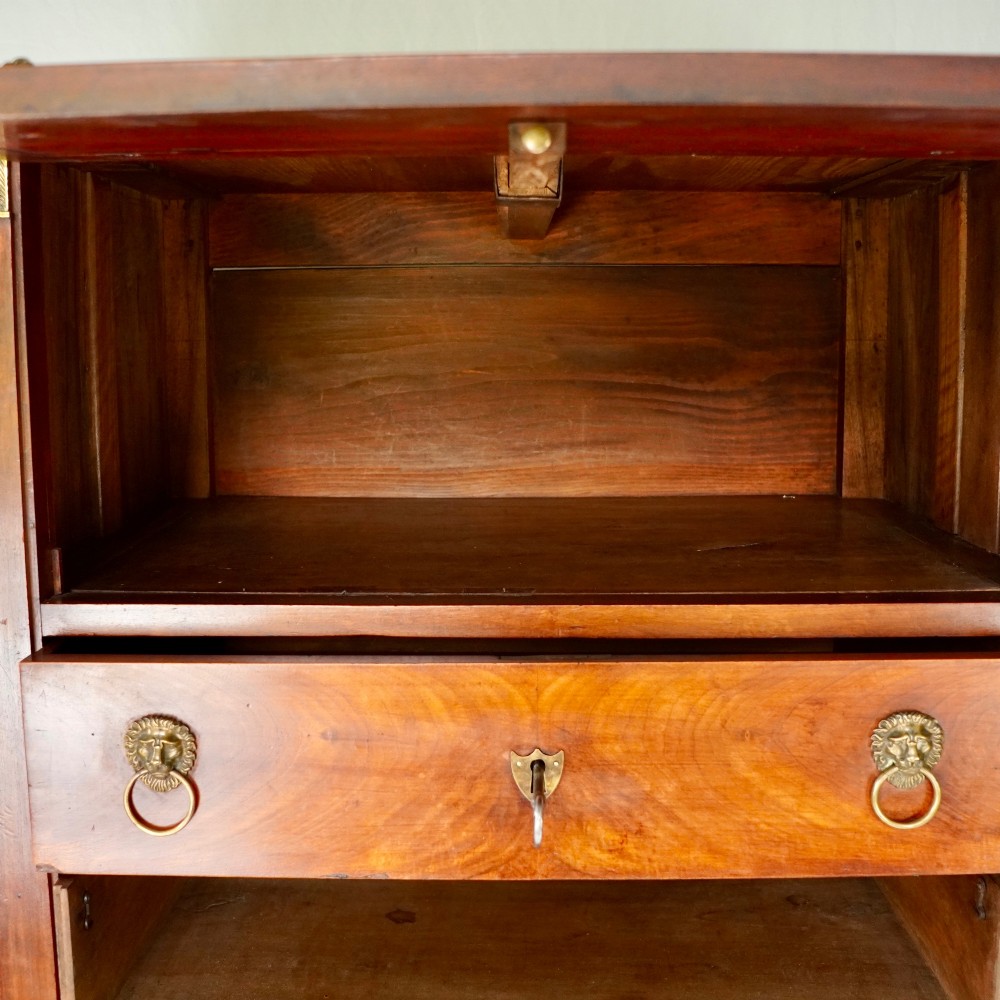A 19th-century French Empire walnut secretaire cabinet featuring multiple drawers, brass lion-head ring handles, and fall-front writing compartments. View II