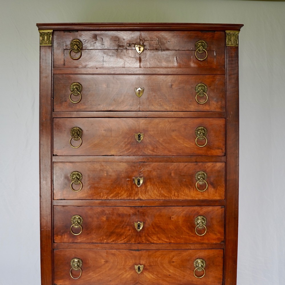 A 19th-century French Empire walnut secretaire cabinet featuring multiple drawers, brass lion-head ring handles, and fall-front writing compartments. View VII