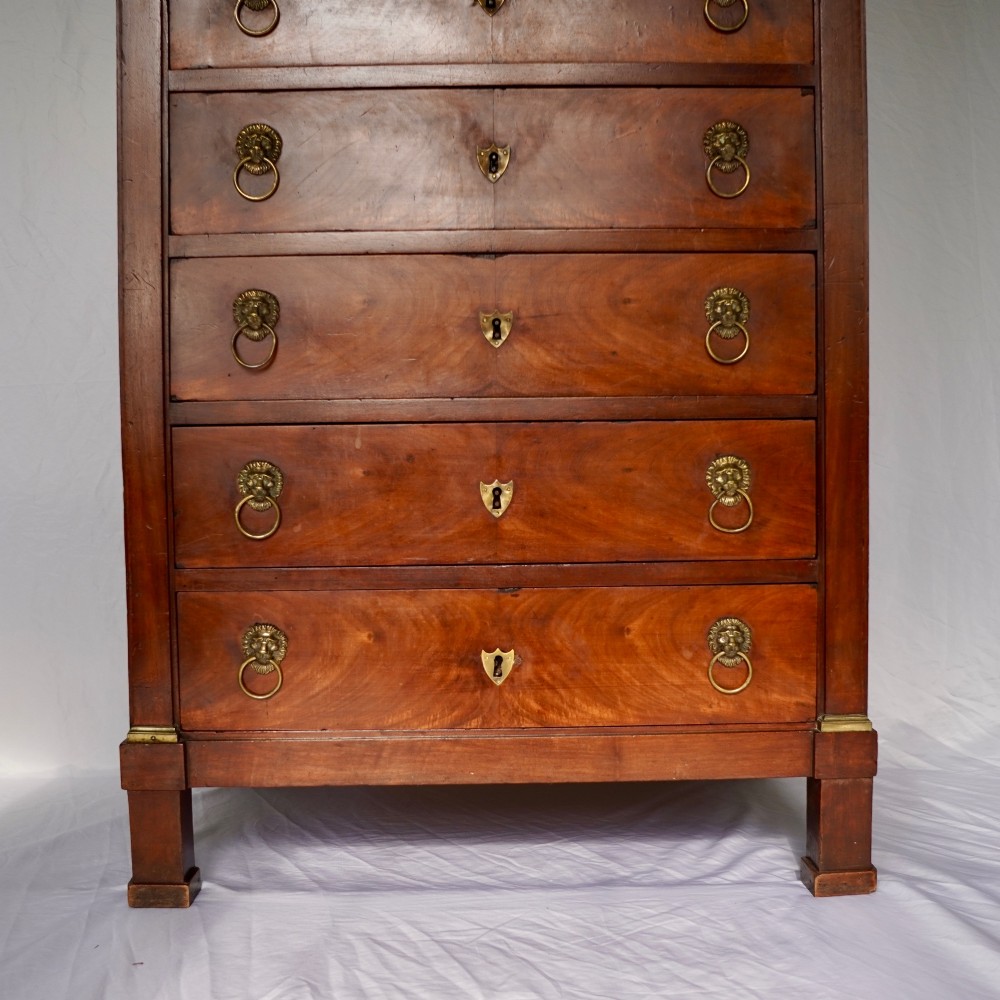 A 19th-century French Empire walnut secretaire cabinet featuring multiple drawers, brass lion-head ring handles, and fall-front writing compartments. View VIII