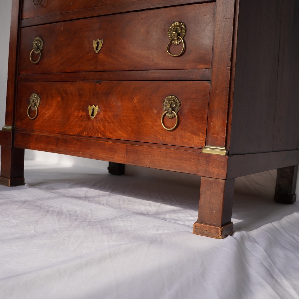 A 19th-century French Empire walnut secretaire cabinet featuring multiple drawers, brass lion-head ring handles, and fall-front writing compartments. View IX