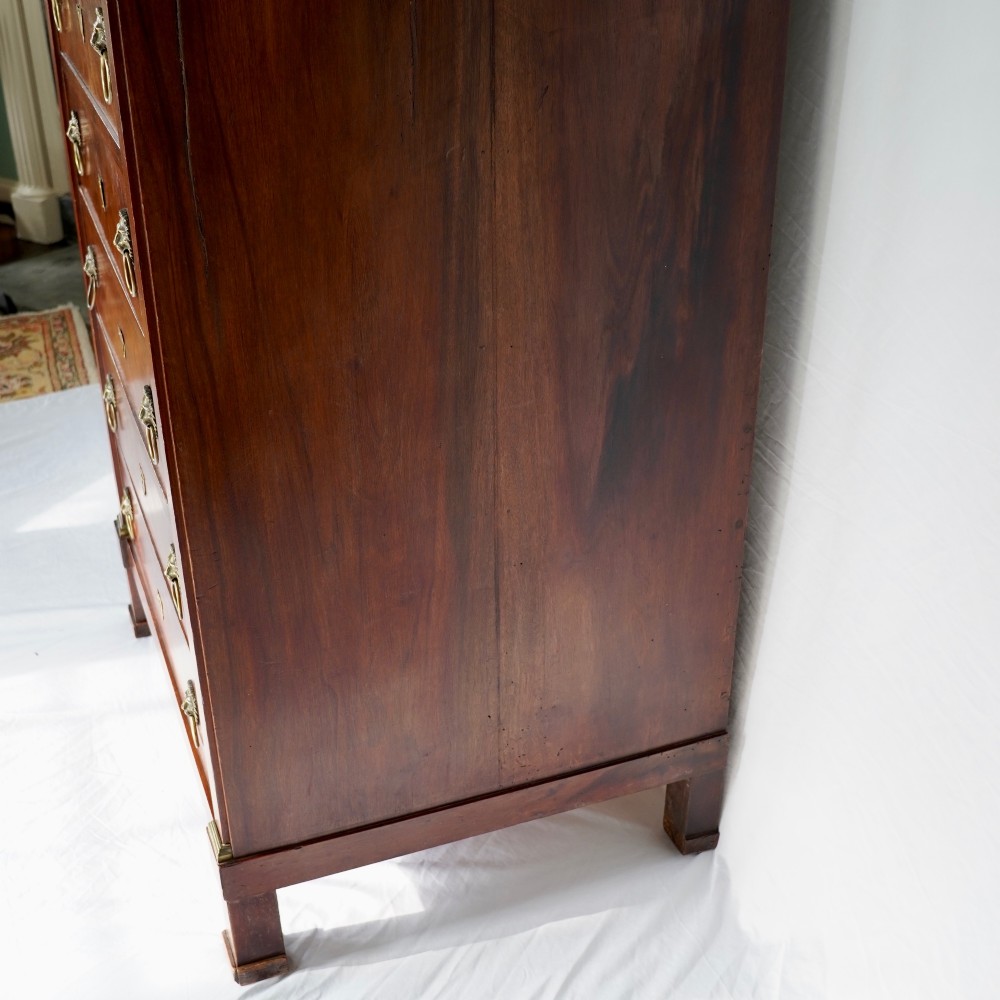 A 19th-century French Empire walnut secretaire cabinet featuring multiple drawers, brass lion-head ring handles, and fall-front writing compartments. View X