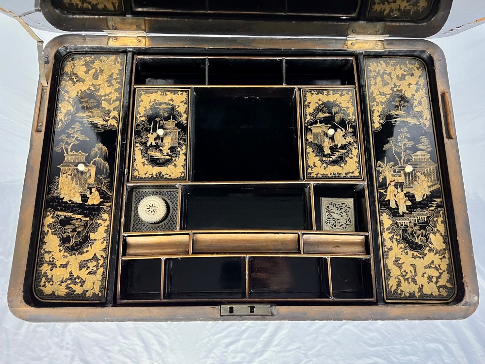A Regency era black lacquered work table featuring detailed gold chinoiserie motifs, turned legs, a stretcher base, and carved paw feet. View III