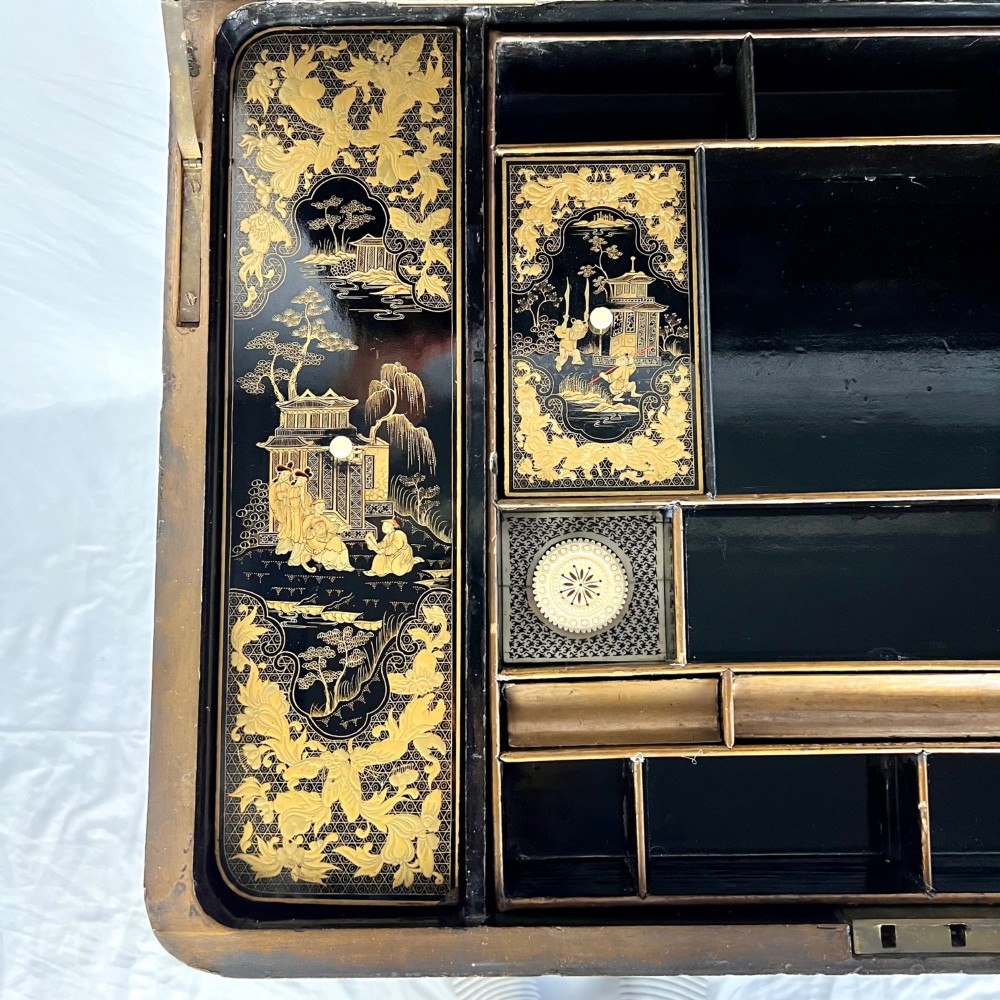 A Regency era black lacquered work table featuring detailed gold chinoiserie motifs, turned legs, a stretcher base, and carved paw feet. View IV