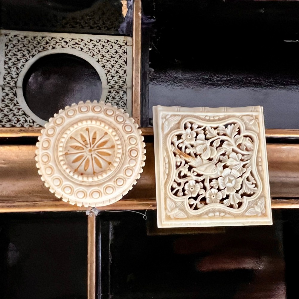 A Regency era black lacquered work table featuring detailed gold chinoiserie motifs, turned legs, a stretcher base, and carved paw feet. View VI
