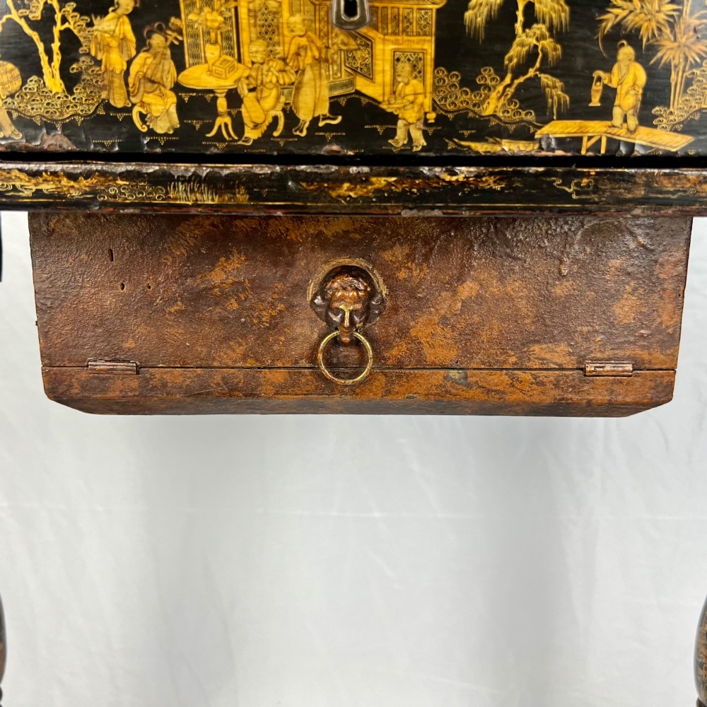 A Regency era black lacquered work table featuring detailed gold chinoiserie motifs, turned legs, a stretcher base, and carved paw feet. View VII