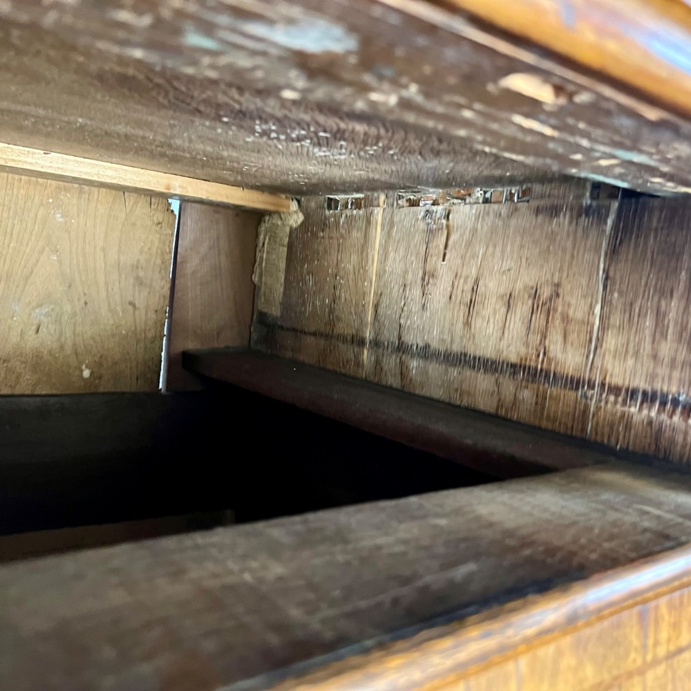 An early 18th-century Queen Anne walnut chest on stand featuring crossbanded drawers, brass teardrop handles, and cabriole legs. View IX
