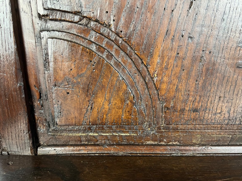 An 18th-century dark chestnut wood lavabo cabinet featuring a carved backboard mounted with a pewter cistern above a matching pewter basin. View VIII